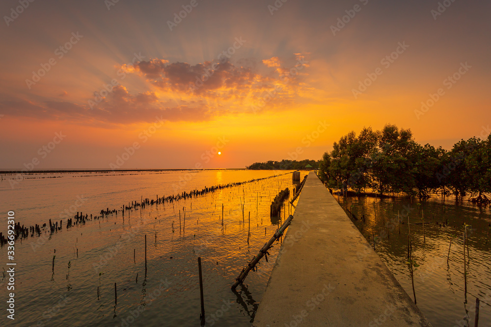 Sunset over the lake in the village ,The bridge stretches out to sea and sunsets in the evening , 
