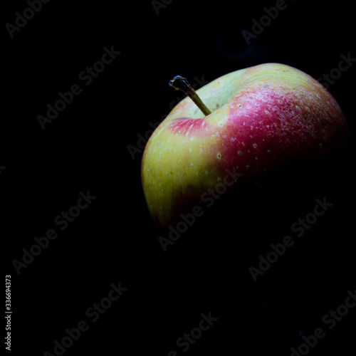 red apple on black background
