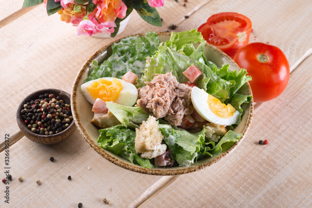 Salad with greens, meat, eggs and tomatoes