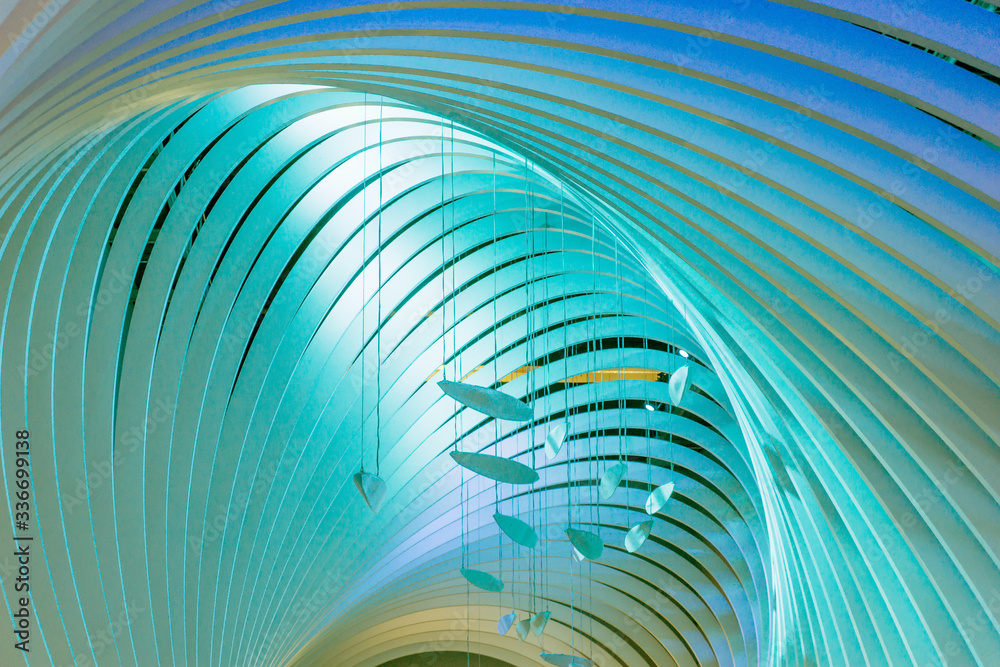 Fototapeta premium Tunnel colored in different shades of blue with lamps as wind play