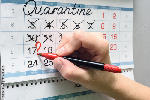 Hand draws a question mark on Monday on the calendar, previous weeks were non-working due to quarantine.