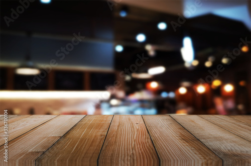 wooden table with abstract blurred background resturant lights used for display montage products mock up design. © thithawat