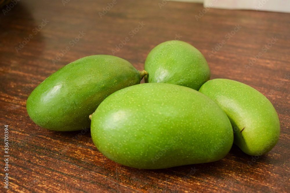 Organic Young Green Mangoes on Wooden Table sour fruits. Organic Young Green Mangoes on Wooden Table sour fruits.