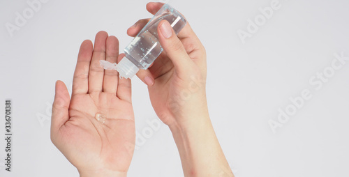 Hands is squeezing alcohol hand gel on white background.