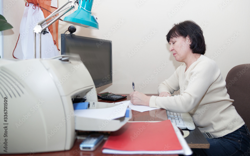 Portrait of   elderly woman at home computer.