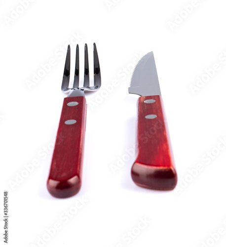 Red fork and knife on white background. (Perspective) photo