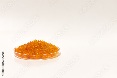 Silica gel dessicant in a dish on a white background