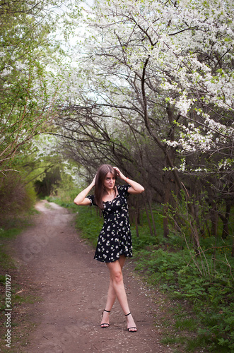 Beautiful girl on   background of flowering trees © DariaTrofimova