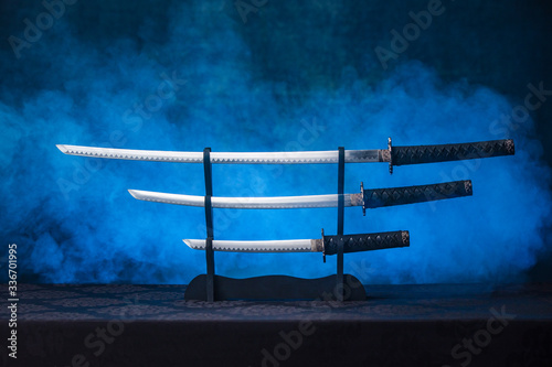 Three swords on a stand with exposed blades photo