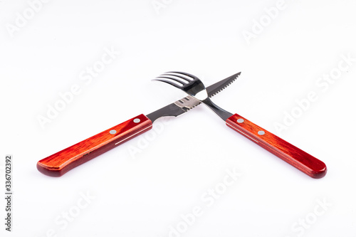 Fork and knife on white background. (Perspective) photo