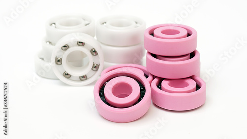 White and pink plastic Ball bearing  On a white background.