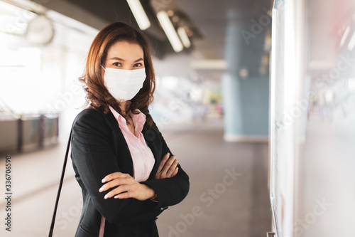 Woman wearing mask reading map.