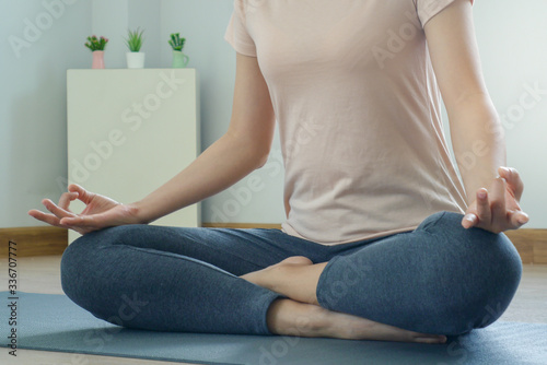 Women doing yoga stay home with a meditation posture. Quiet relaxation in the morning for strong mental and physical health.