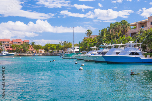 Harbor / marina in Puerto Aventuras with boats on a sunny day. The beautiful and popular coastal city in Riviera Maya, Mexico. © Ирина Васильева