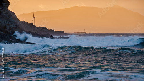 Azkorri (Getxo Basque Country) beach at sunset Orange sunset with rocks and waves
