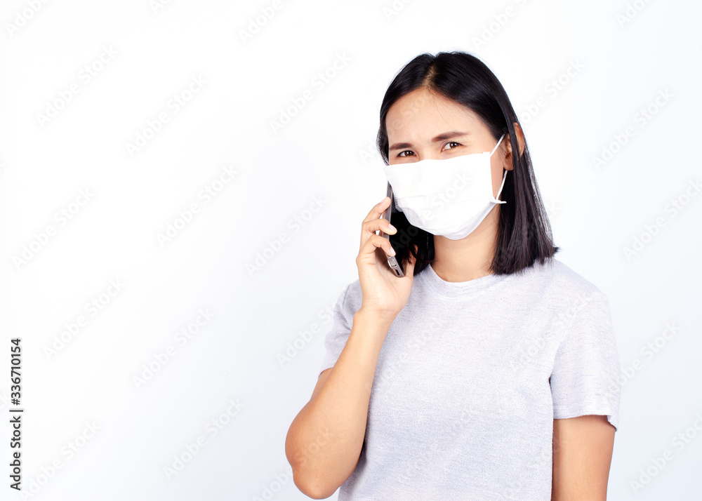 Asian woman portrait wearing mask for protect Covid 19 or coronavirus with using smartphone Asian woman portrait wearing mask for protect Covid 19 or coronavirus with using smartphone