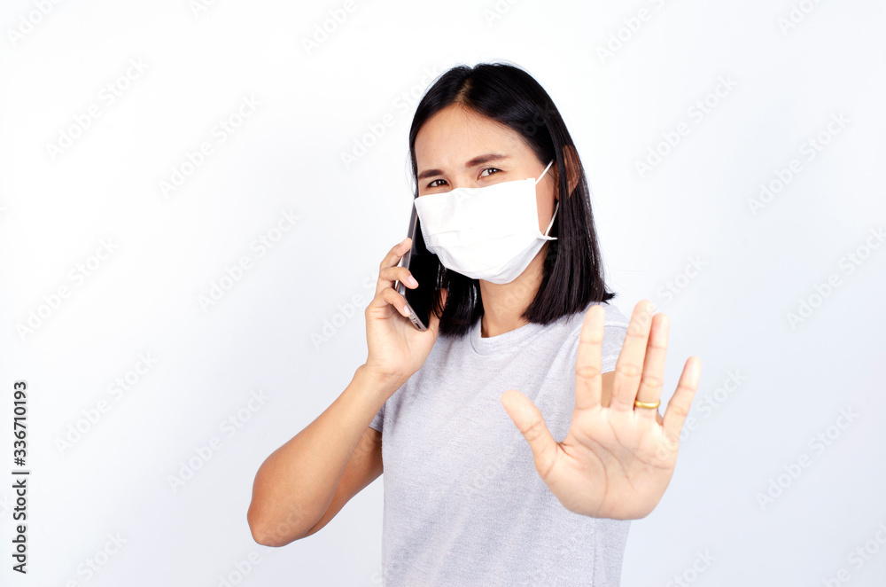 Beatiful asian woman portrait wearing mask and show stop hands gesture for Covid 19 or coronavirus Beatiful asian woman portrait wearing mask and show stop hands gesture for Covid 19 or coronavirus