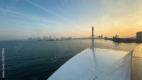 Beautiful sunset view from a boat to the skyline of Abu Dhabi