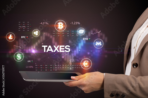 Close-up of a touchscreen with TAXES inscription, business opportunity concept