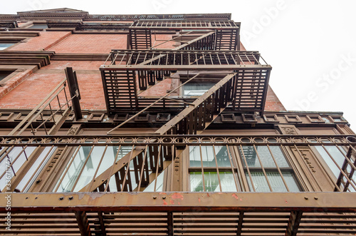 Low Angle View of Typical Apartments with Fire Escape Ladders in New York City, USA