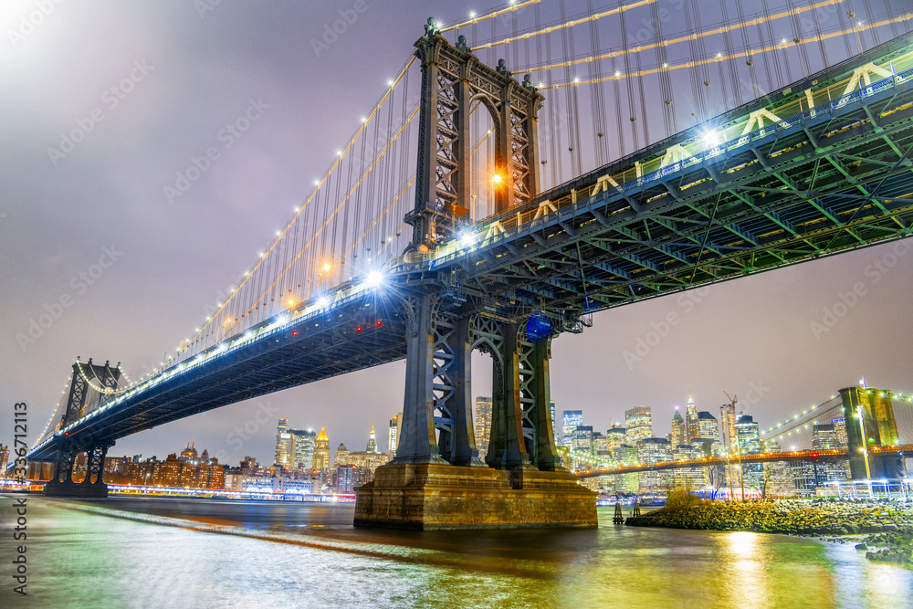 Fototapeta premium Amazing night view of Manhattan and Brooklyn Bridge at night, winter season, New York City