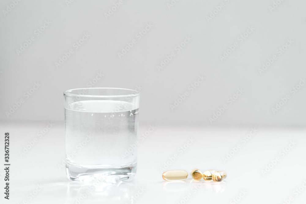 Medical mood - glass of drinking water and pills (tablets or drugs). Medical mood - glass of drinking water and pills (tablets or drugs).
