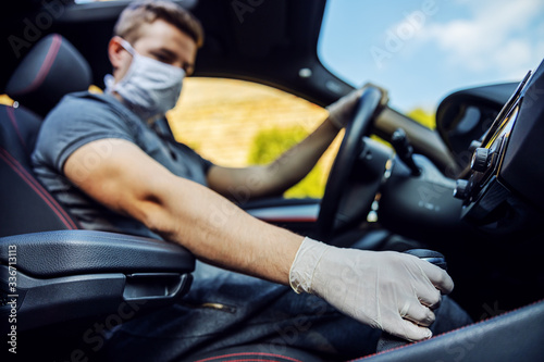 Man with protective mask and gloves driving a car. Infection prevention and control of epidemic. World pandemic. Stay safe. © dusanpetkovic1