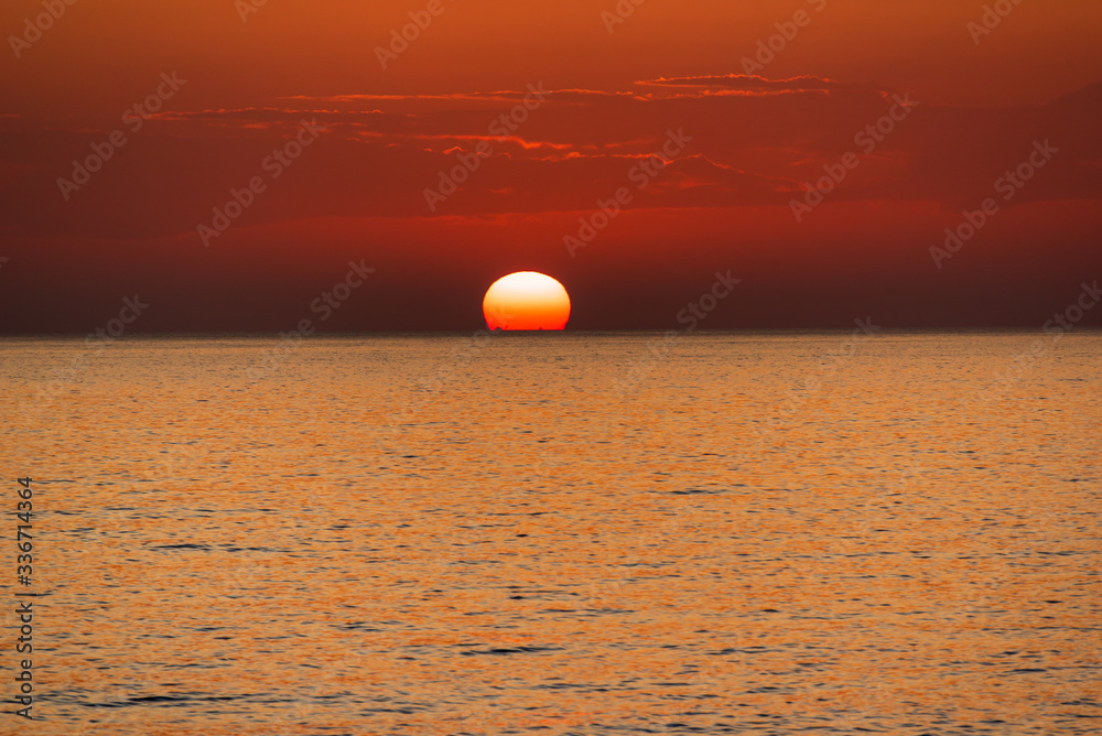 Beautiful wide orange colorful sunset on the sea, peaceful and idyllic