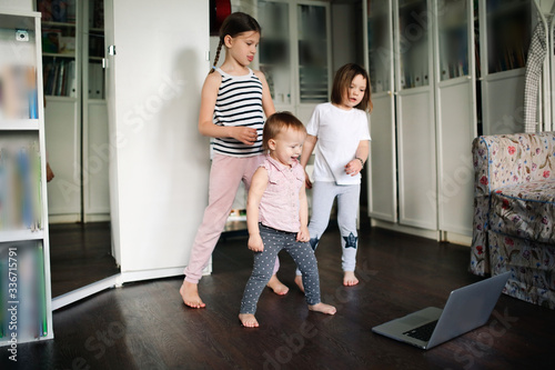 Three children dancing in video chat online