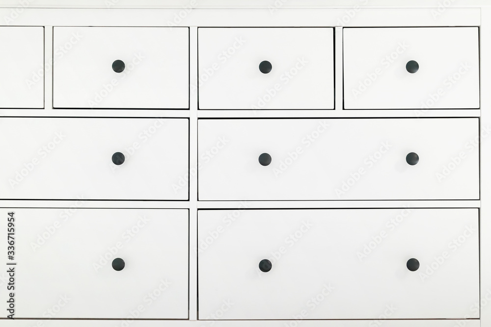 large white Cabinet with drawers and black round handles large white Cabinet with drawers and black round handles
