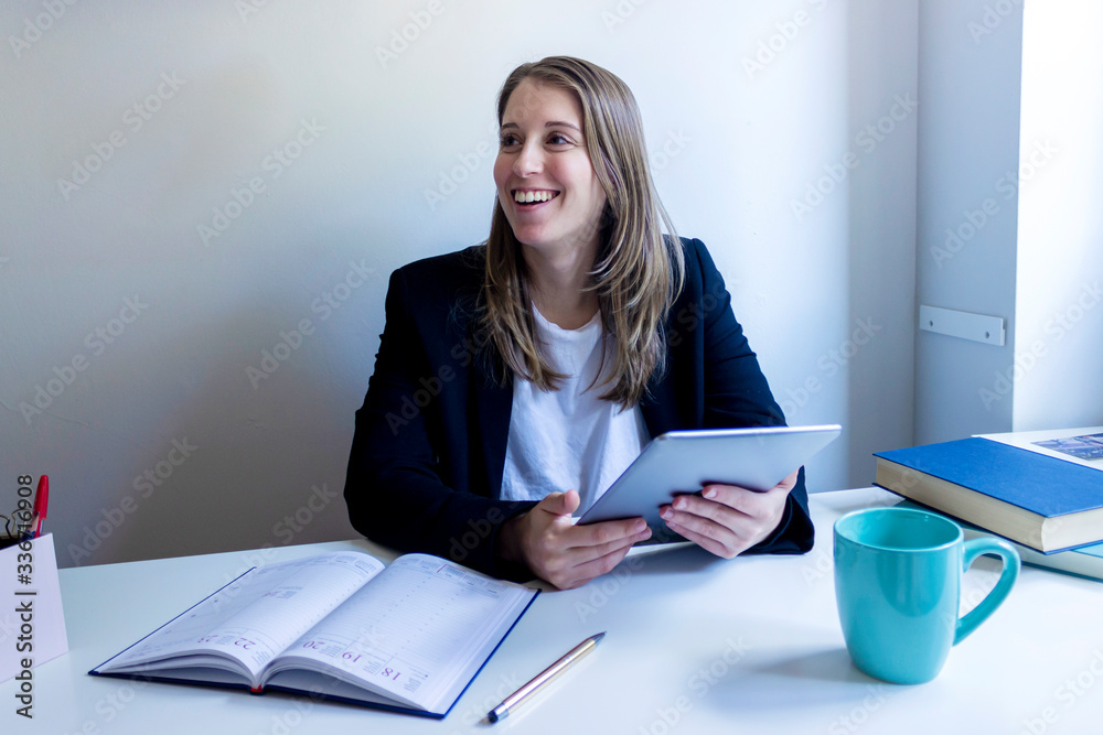 Young entrepreneur woman working at home, writing down business