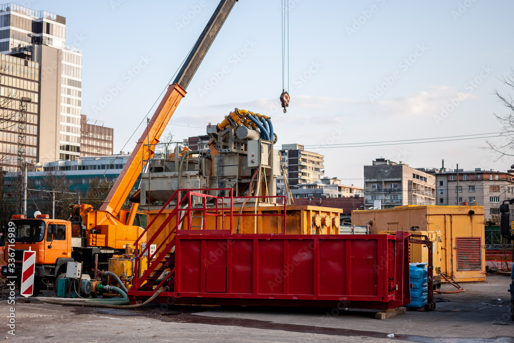 construction works yellow crane and red container construction works yellow crane and red container