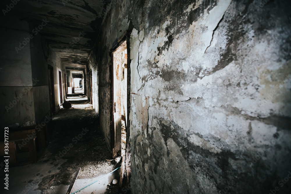 Abandoned building corridors with an eerie atmosphere. Dark tourism concept image. 