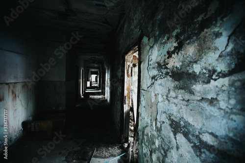 Abandoned building corridors with an eerie atmosphere. Dark tourism concept image. 