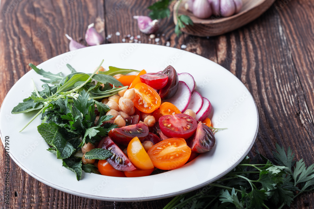 Vegan plant based dish with chickpeas, fresh vegetables and herbs