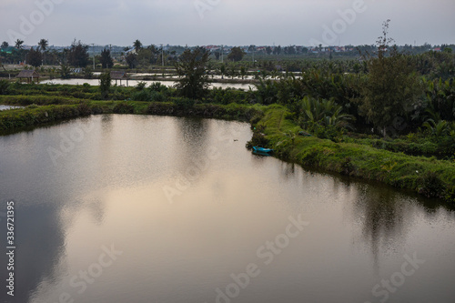 Rural scenery with houses, river, vegetation on Long Tau (Song Long Tau) river banks in suburb of Ho Chi Minh City (Saigon) in Vietnam.