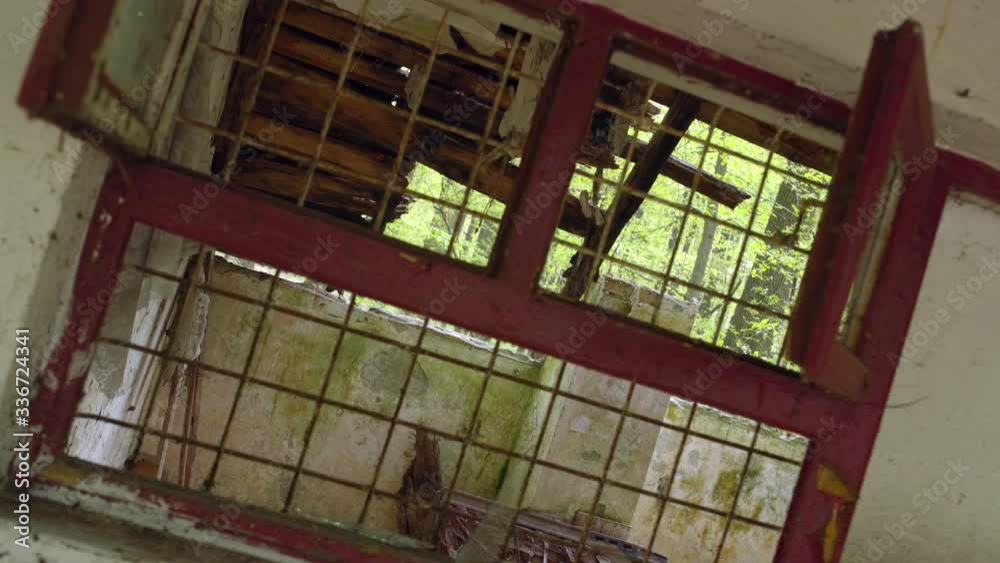 Dutch angle decrepit abandoned gloomy cabin with barred windows in forest. Dutch angle decrepit abandoned gloomy cabin with barred windows in forest.