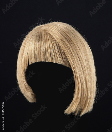 Blond hair female wig isolated on black background
