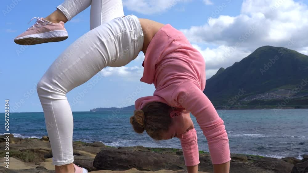 Bright Flexible Girl Gymnast With Curly Hair On Volcanic Coast Ocean 