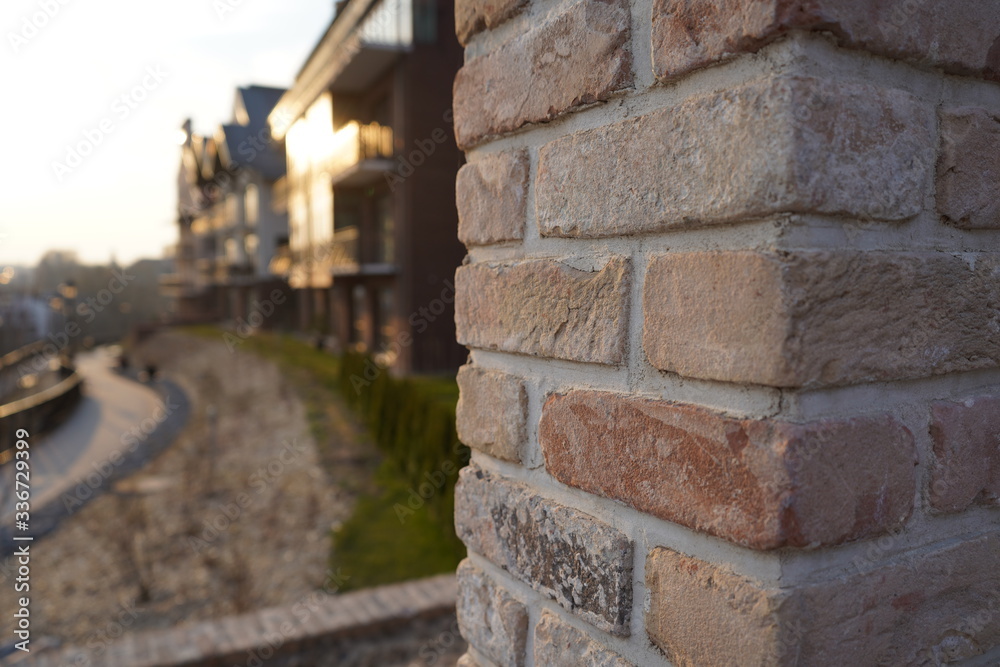Old brick wall and modern architecture buildings in the background during sunset Old brick wall and modern architecture buildings in the background during sunset