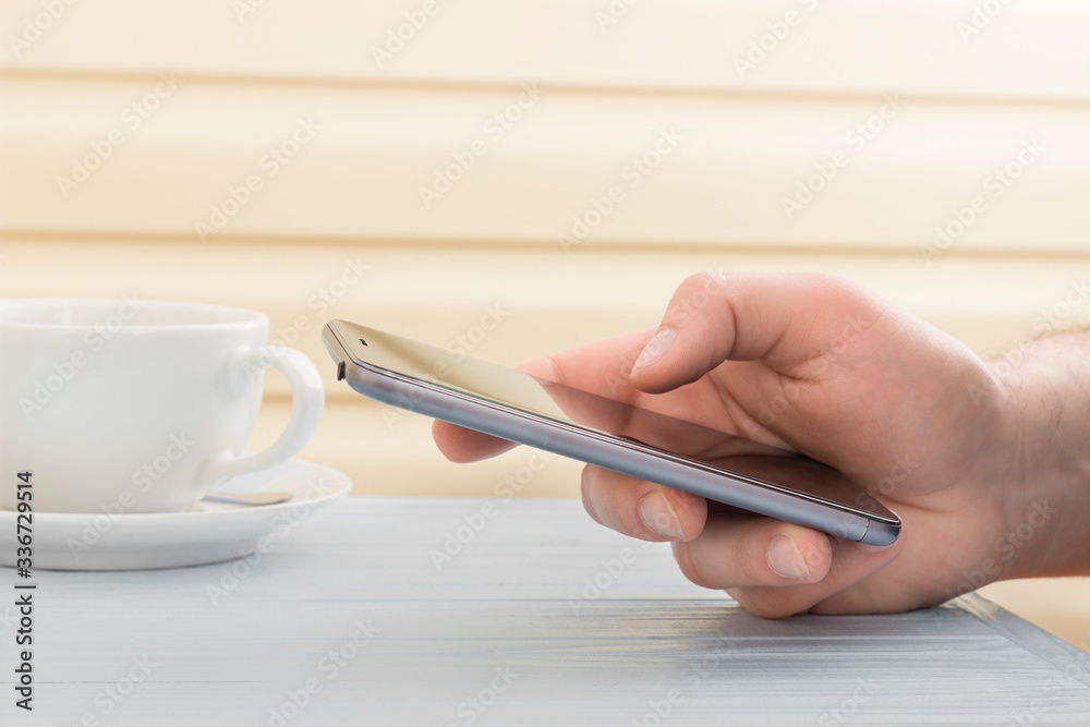 man works in the phone in a cafe
man works in the phone in a cafe