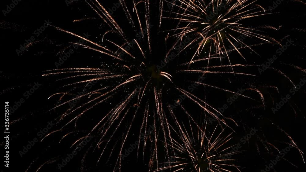 Real fireworks in dark. abstract real golden shining fireworks with bokeh lights in dark night sky. glowing fireworks show. New year fireworks show celebration. Real fireworks in dark. abstract real golden shining fireworks with bokeh lights in dark night sky. glowing fireworks show. New year fireworks show celebration.