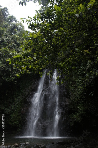 a beautiful waterfall at the foot of the mountain