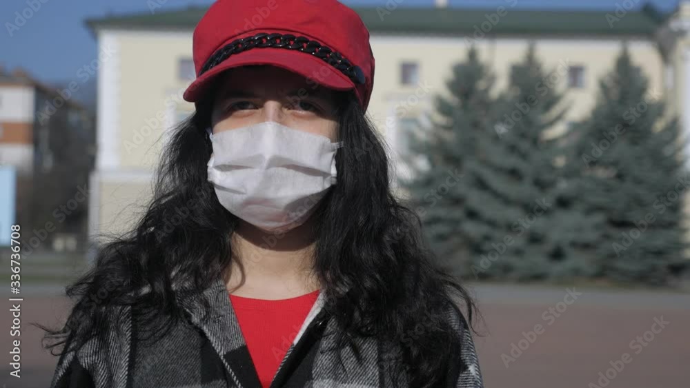 Girl in a medical protective mask. Virus epidemic in the city. Coronavirus. Covid 19. Pandemic of a dangerous disease in the world. Girl in a medical protective mask. Virus epidemic in the city. Coronavirus. Covid 19. Pandemic of a dangerous disease in the world.