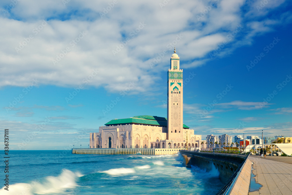 Cold waves of Atlantic wash over beautiful Hassan II Mosque towering above the city. Casablanka, Morocco