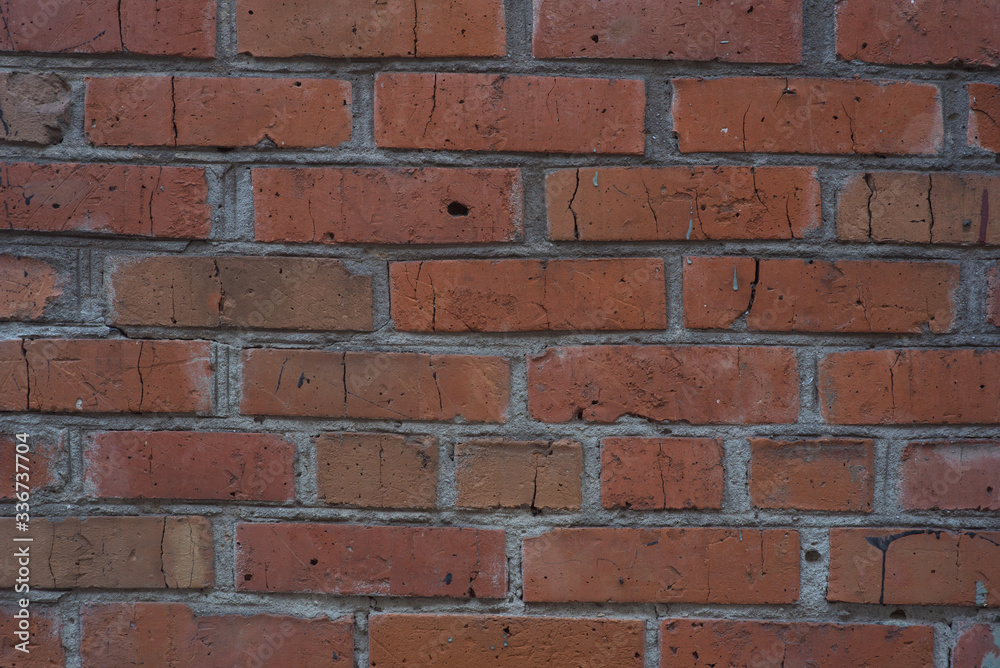 Brick masonry of bright red color in the form of a wall Brick masonry of bright red color in the form of a wall