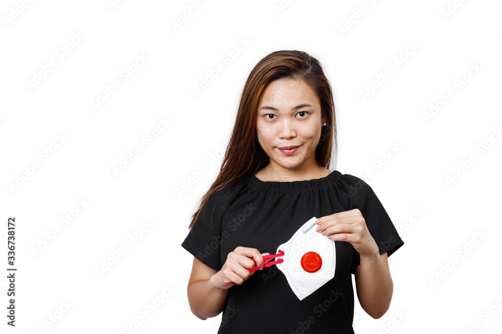 Asian lady standing holding face mask front view in a white plain background space available for text. Young lady half body view showing face mask for use to helps protect health against coronavirus. Asian lady standing holding face mask front view in a white plain background space available for text. Young lady half body view showing face mask for use to helps protect health against coronavirus.