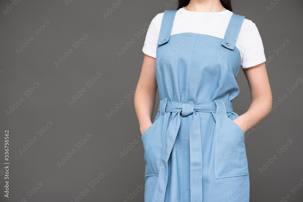 Woman in blue dress on gray background with copy space. Woman in blue dress on gray background with copy space.