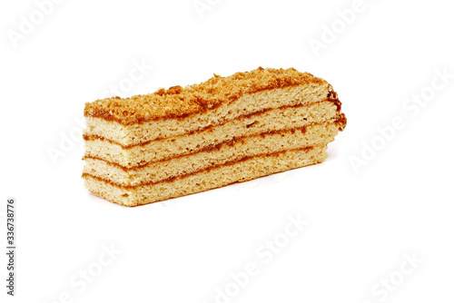 piece of layered honey cake isolated on white background