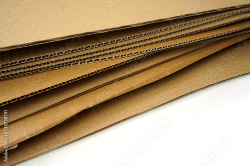 Close-up of stacked corrugated cardboard on white background.